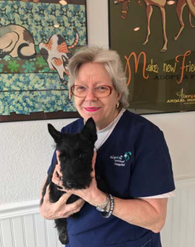 Team member Jan holds a black Scottie dog